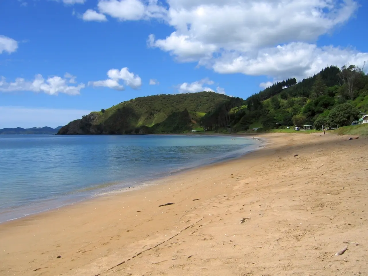 On the left side of the image there is a sea. In the center there are hills. At the top there is...