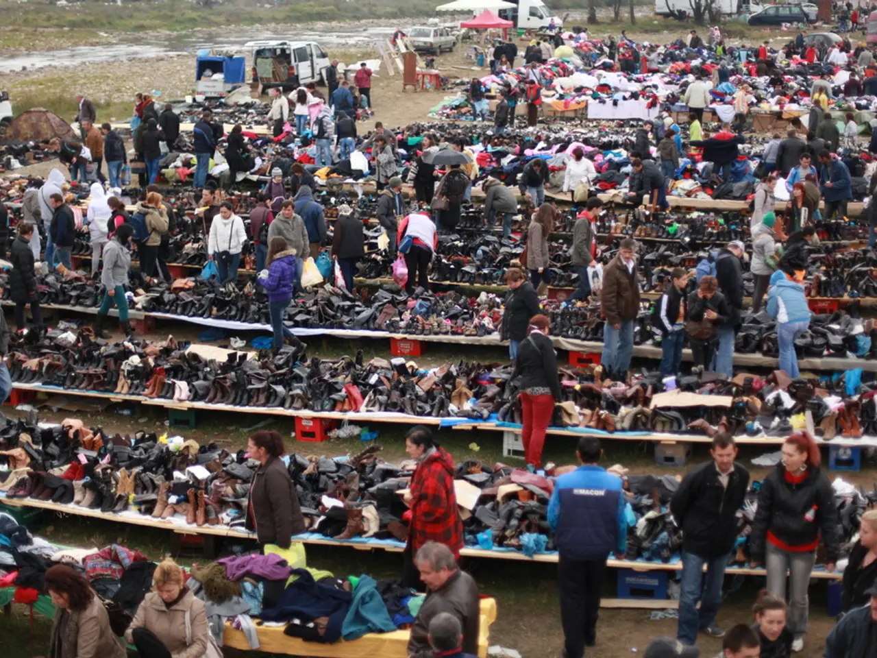 This image is taken in the market. In this image there are many people. We can see shoes, clothes...