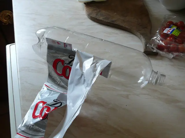 There is an empty coca cola bottle with its label being torn and beside the bottle there are...