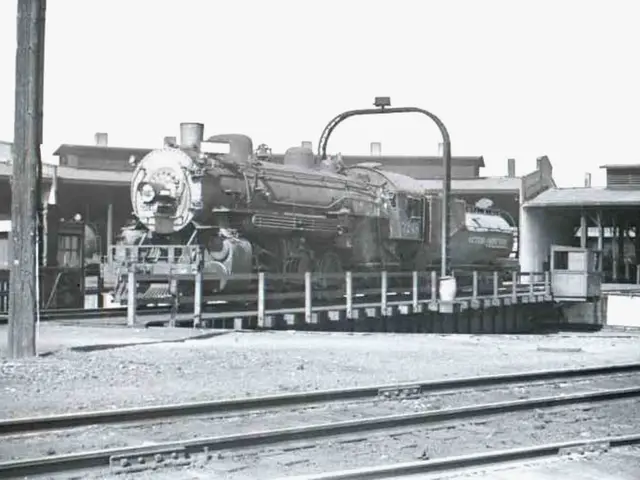 In this picture we can see a train in the middle of the image, and we can find few tracks,...