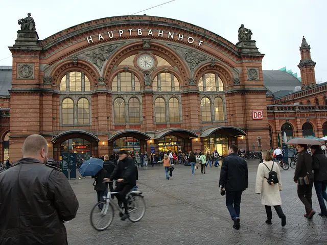 In this image we can see there is a building which has sculptures, a clock and some text on it, in...