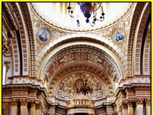 This is an inside picture of the church, there are some statues, pillars, chairs and some other...